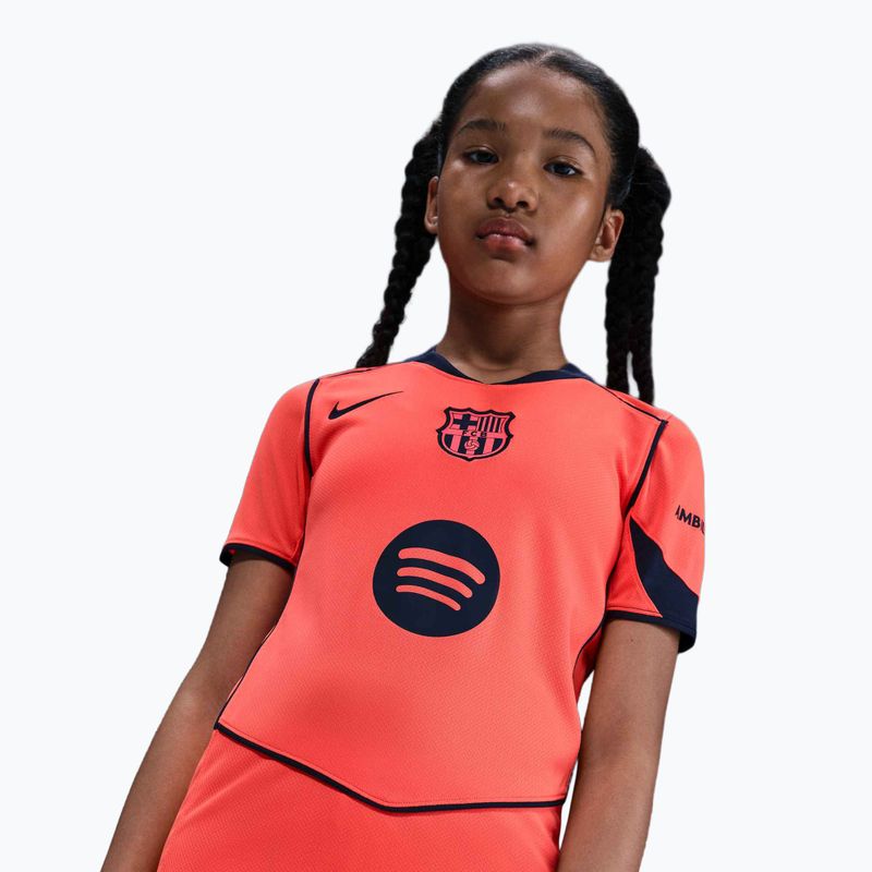 Футболка футбольна дитяча Nike FC Barcelona 2025/26 Stadium Third Jr bright mango/midnight navy/midnight navy 7